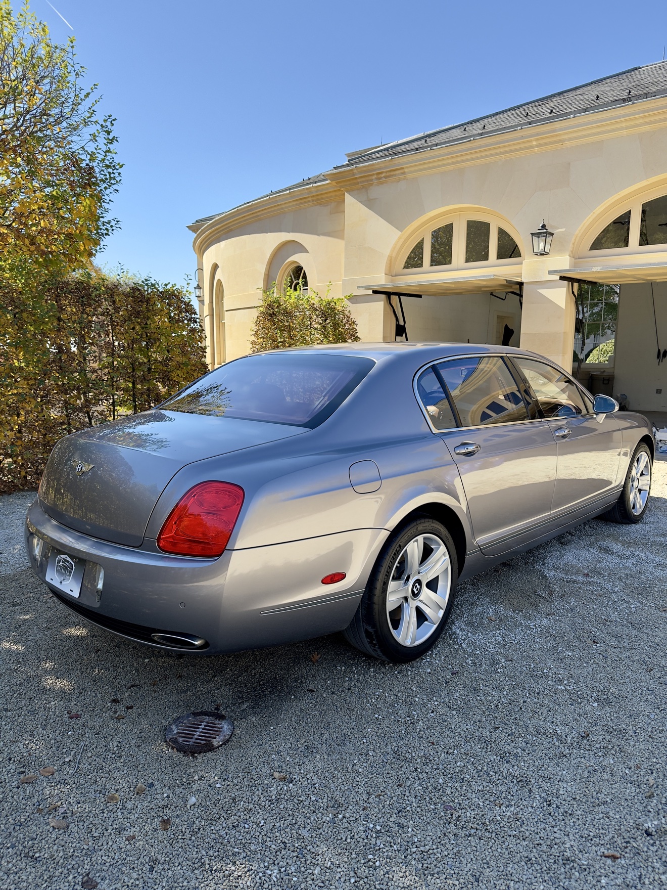 Silver Bentley Continental rear angle view after detailing