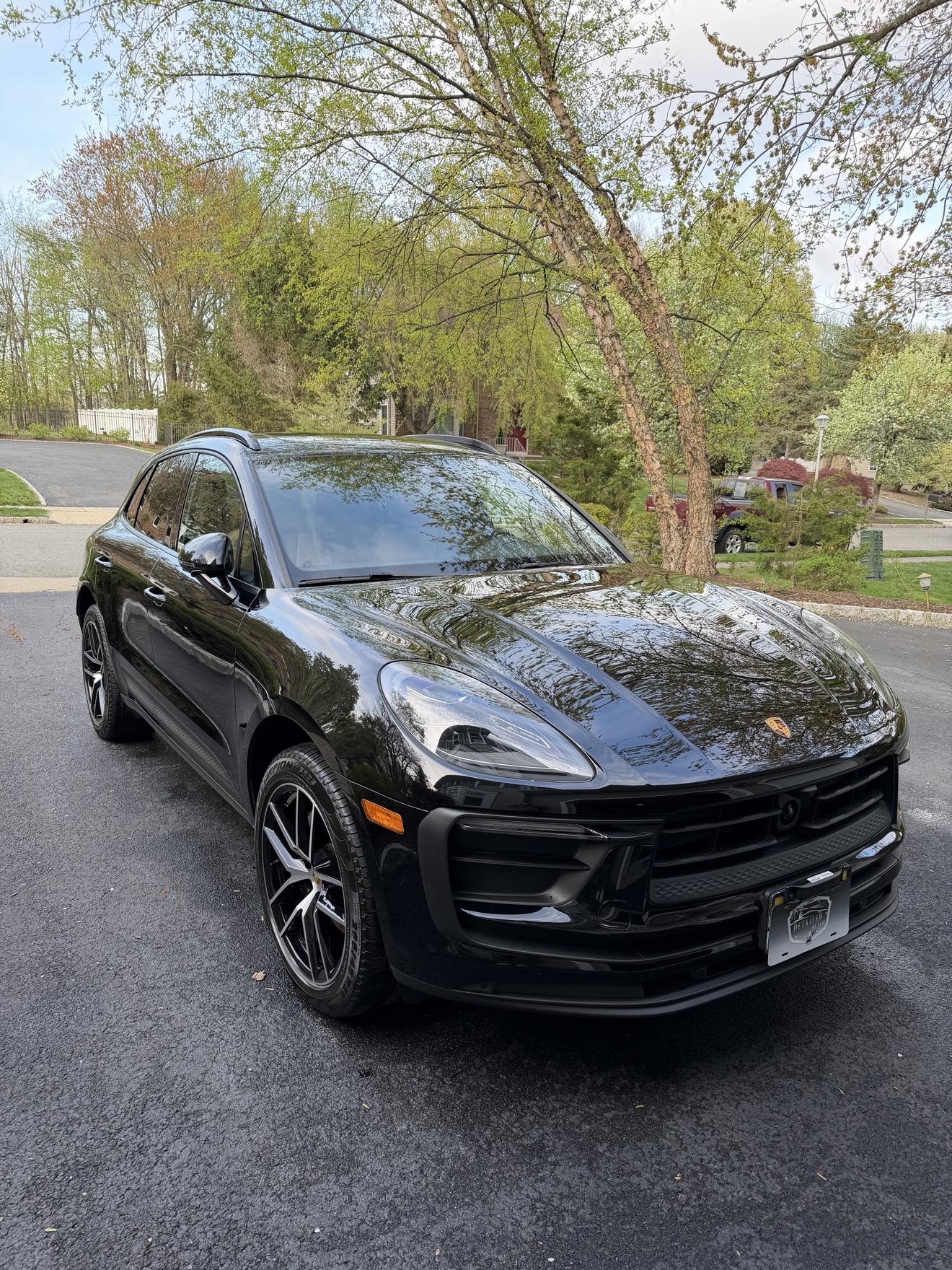 Black Porsche Macan front three-quarter view after detailing