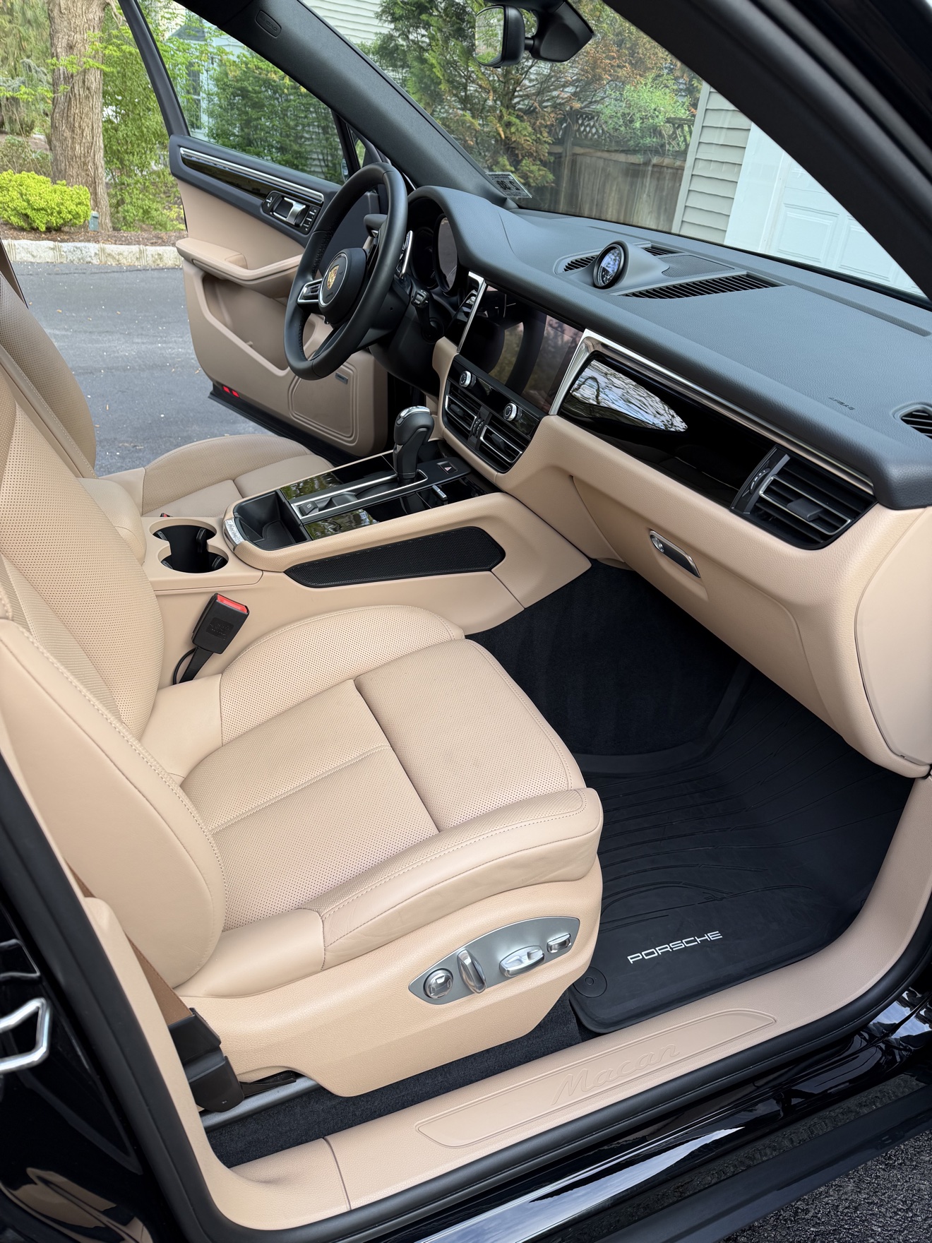 Porsche Macan cockpit with beige leather and center display after detailing