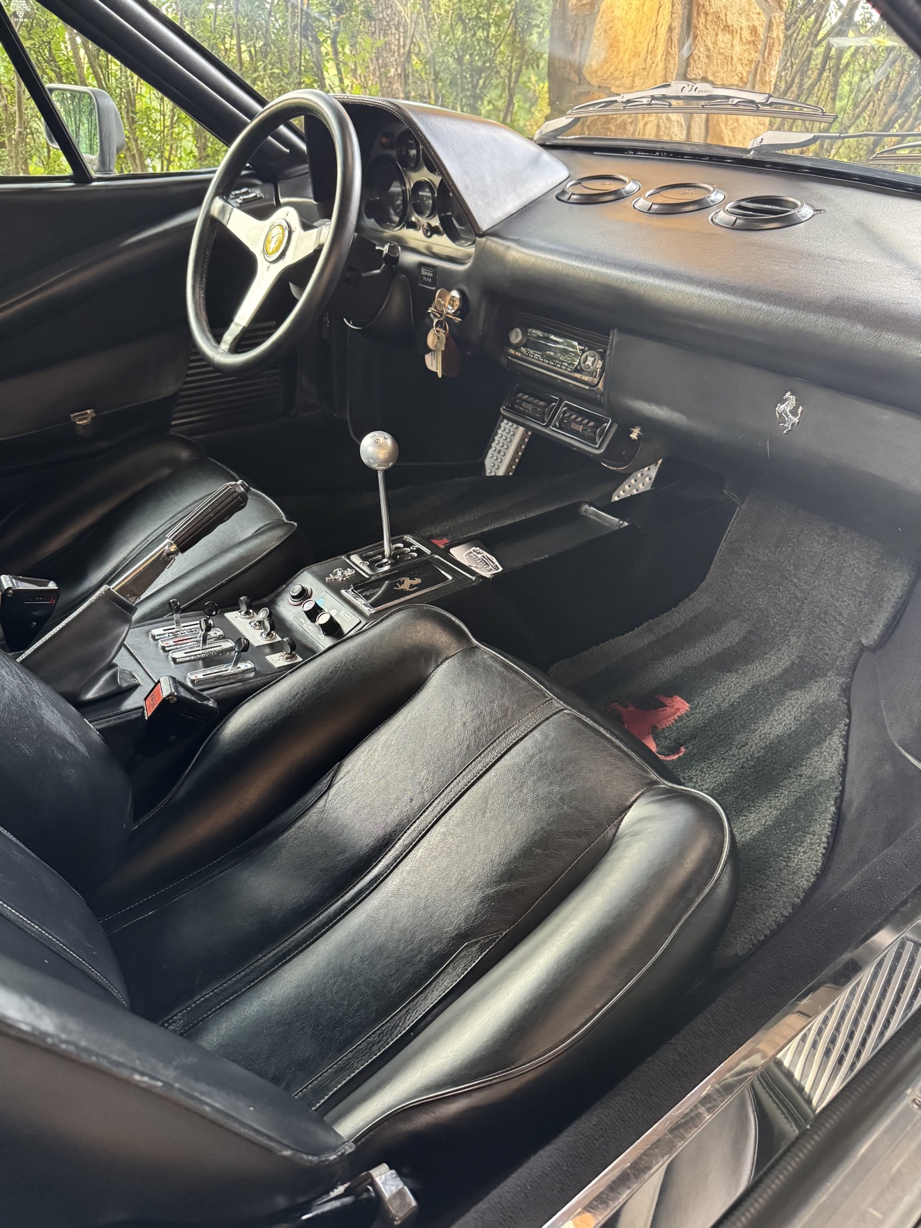 Ferrari 308 GTS driver cockpit with black leather seats after detailing