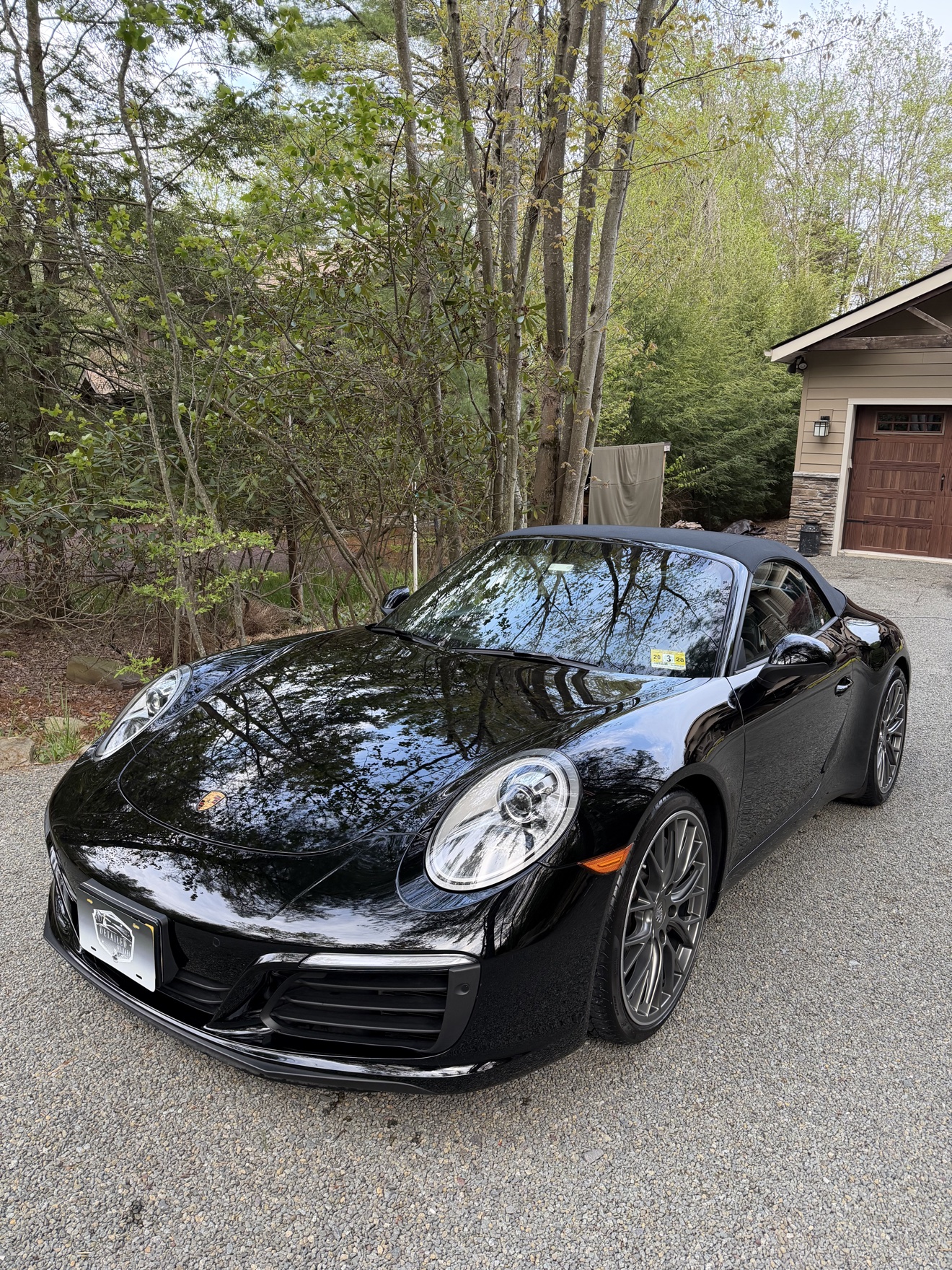 Black Porsche 911 Carrera Cabriolet front angle view after detailing