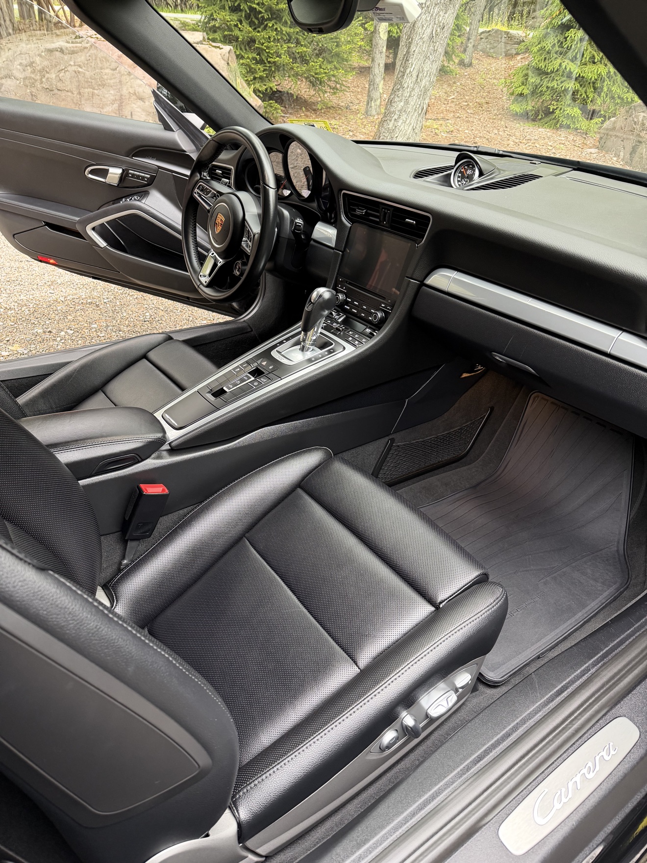 Porsche 911 Carrera passenger cockpit with black leather and Carrera sill plate