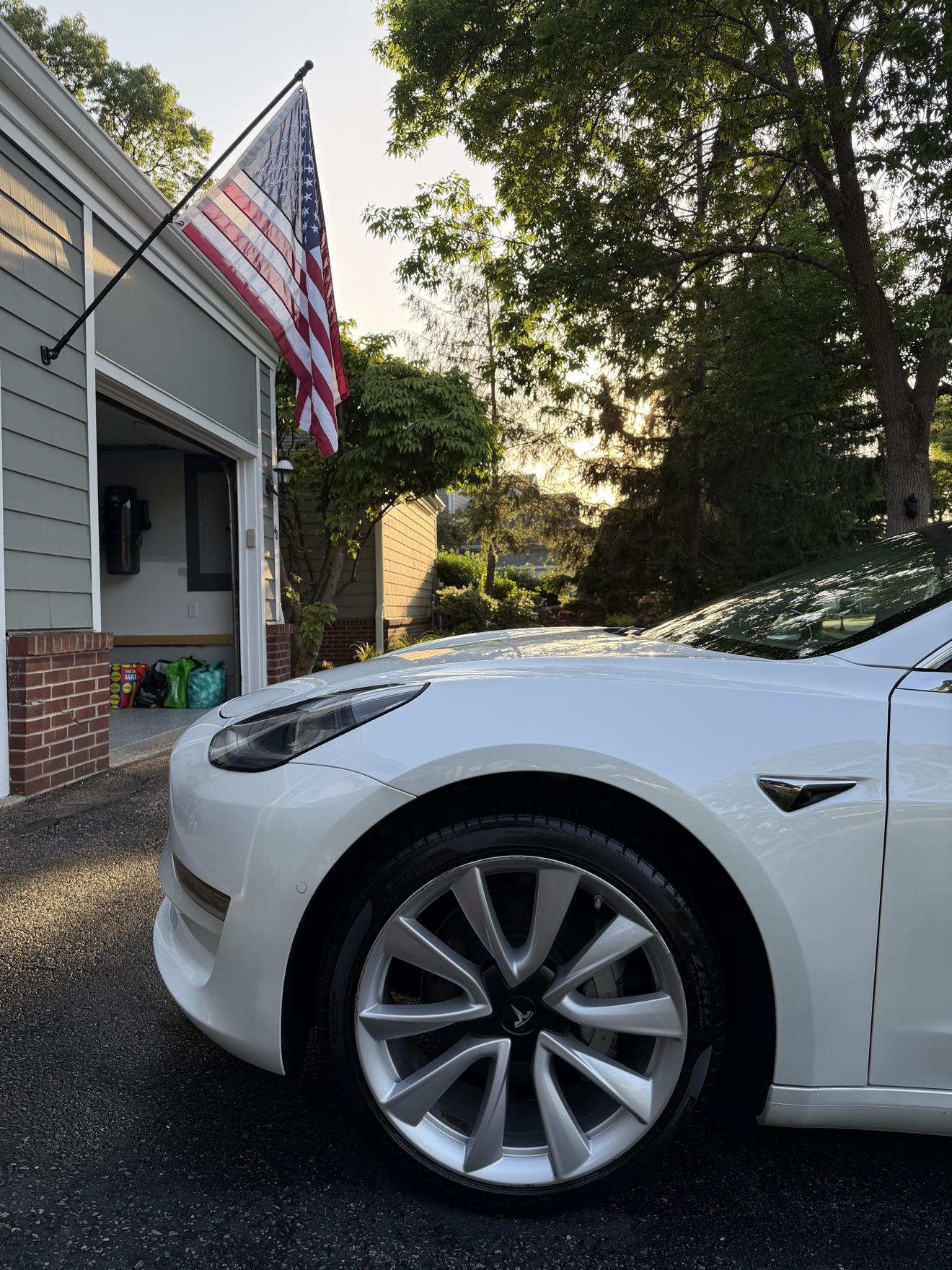 Close-up of the front wheel on a white Tesla Model 3 after detailing