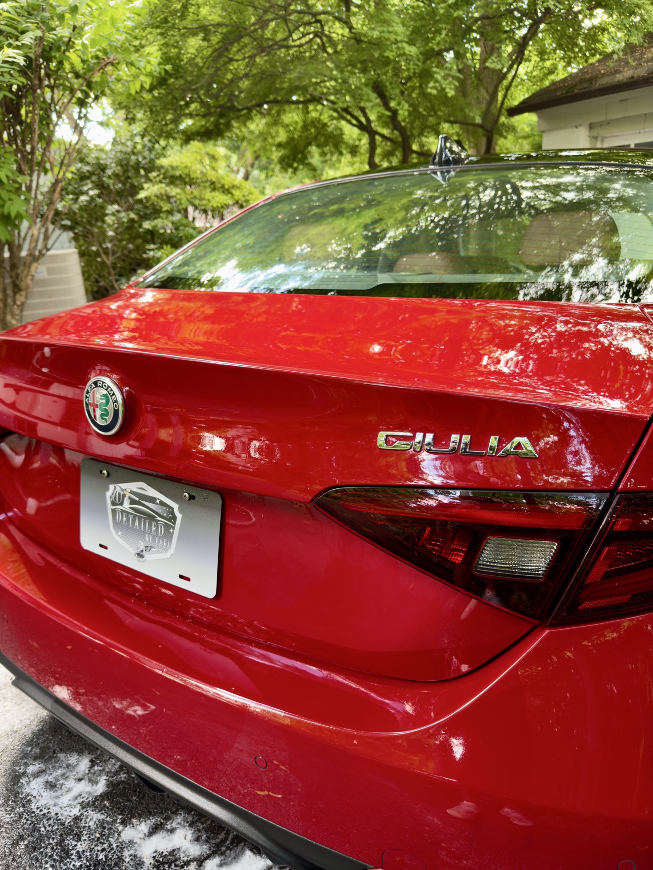Close-up of the GIULIA badge on the rear of a red Alfa Romeo Giulia Q4
