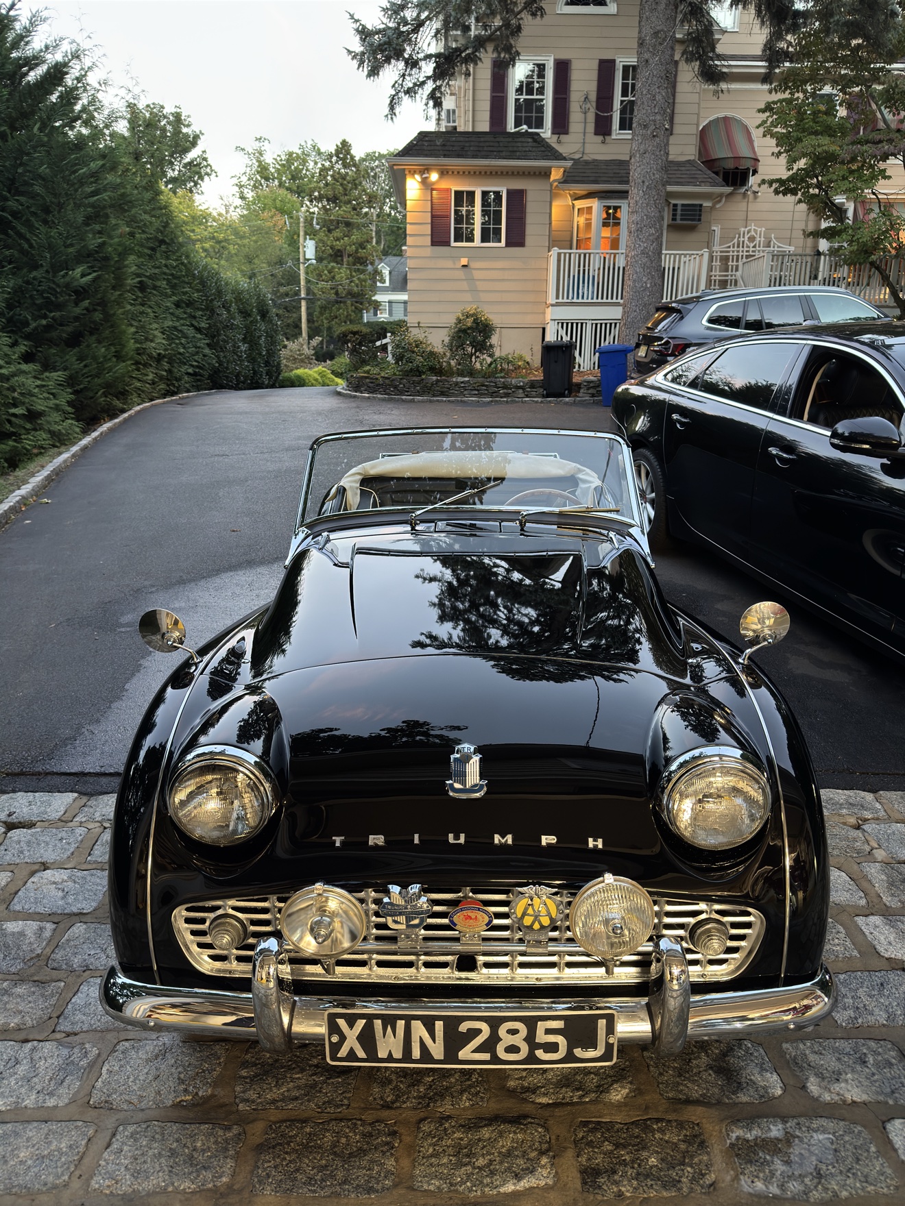 Front view of a black Triumph TR3 with grille badges after detailing