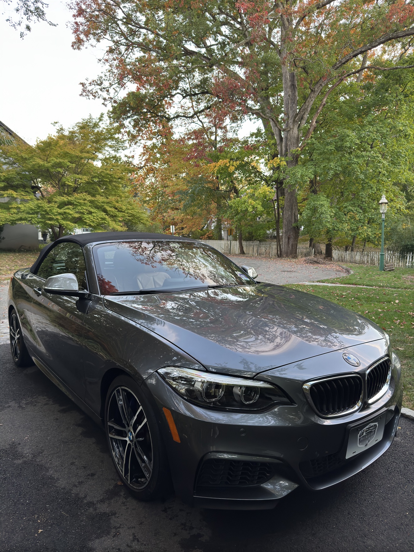 Gray BMW M240i convertible front three-quarter view after detailing