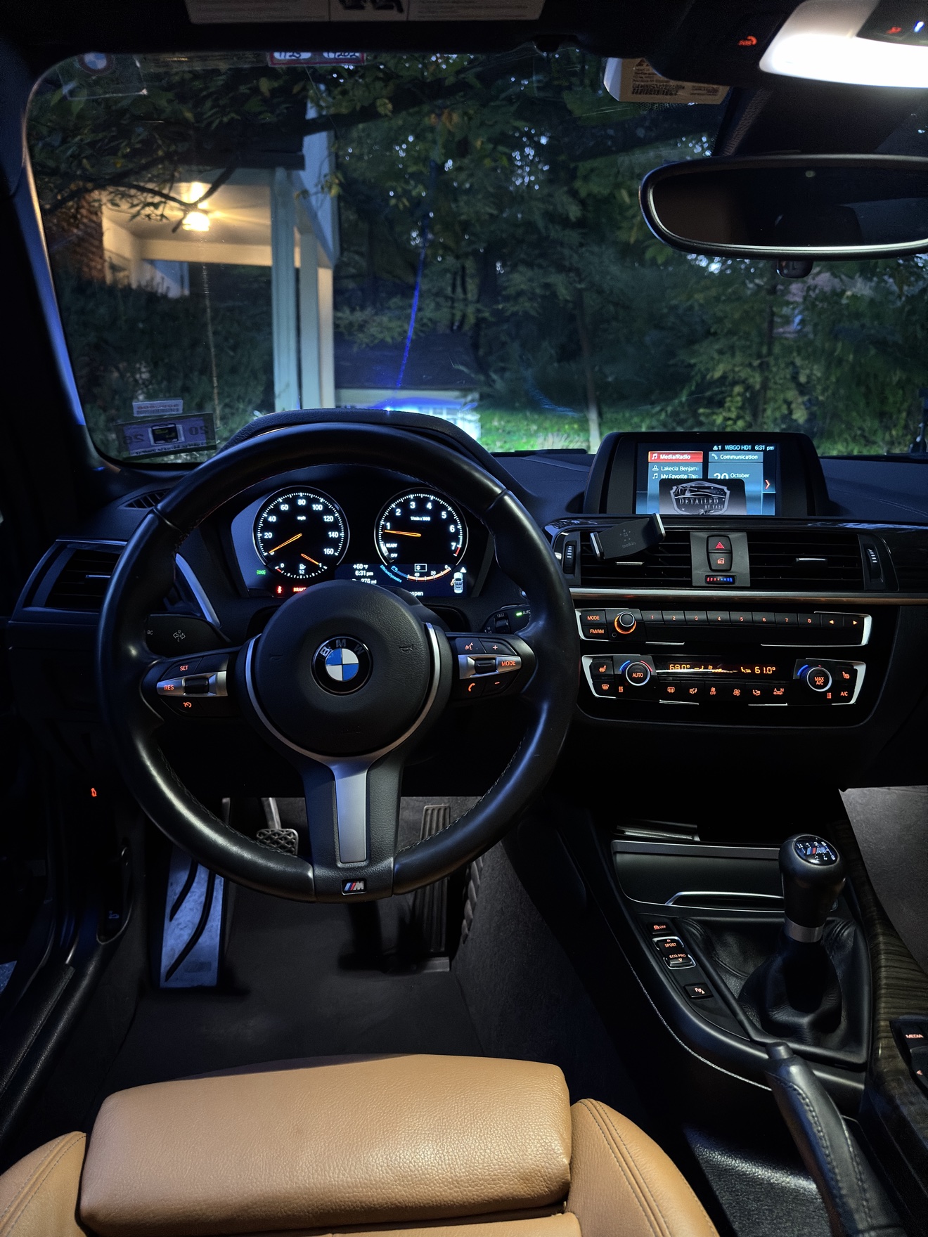 BMW M240i cockpit at night with tan leather seats and manual shifter