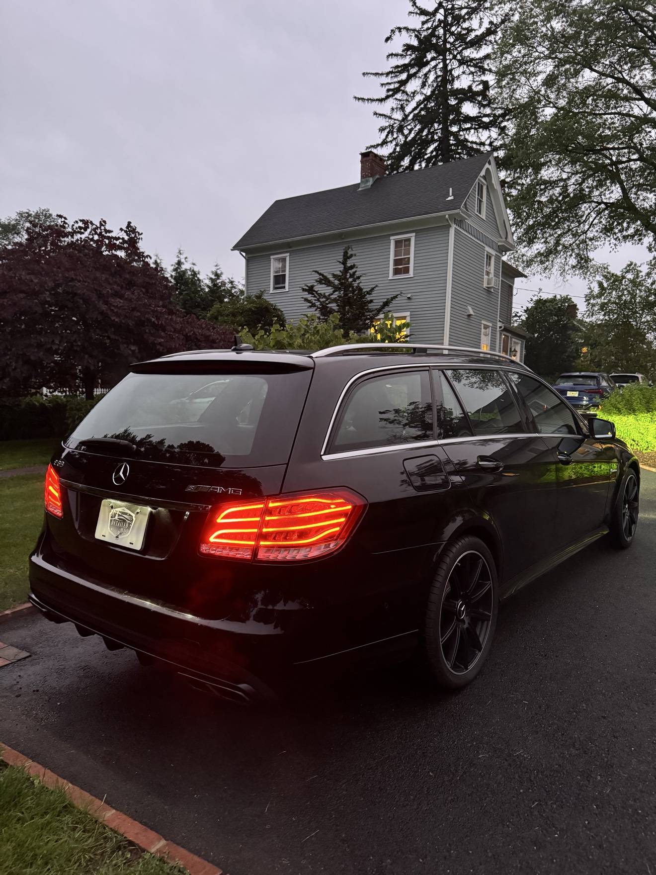 Black Mercedes Benz E63 S AMG wagon rear angle view after detailing