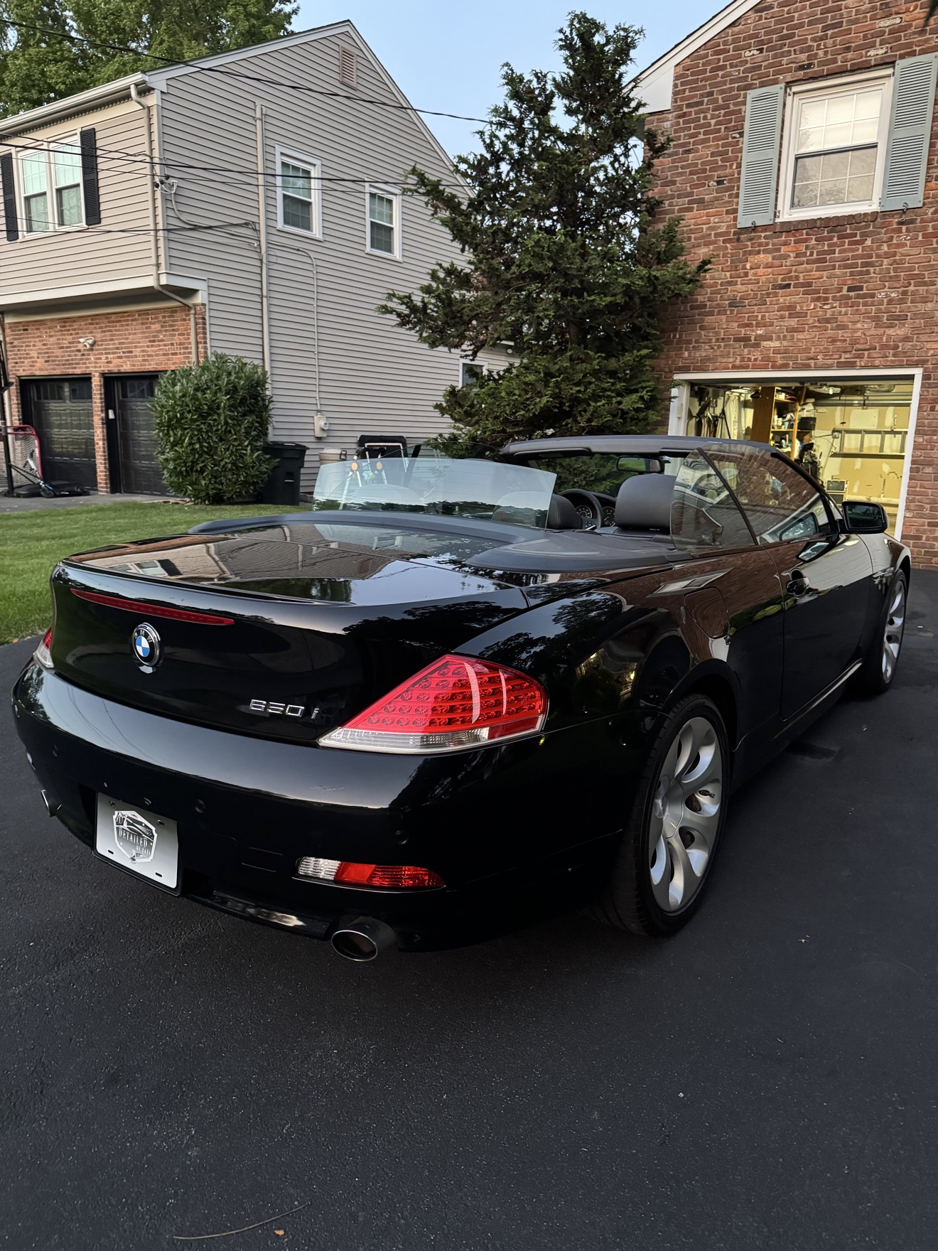 Black BMW 650i convertible rear angle view after detailing