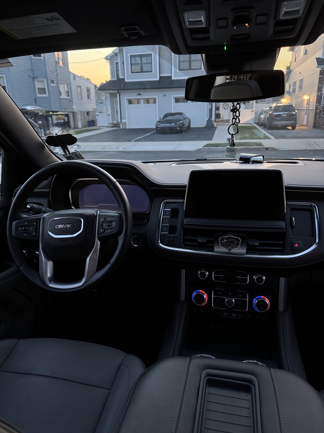 GMC Yukon SLT driver cockpit with black leather interior after detailing
