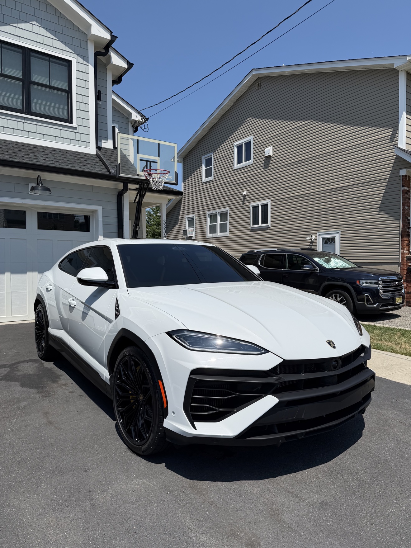 White Lamborghini Urus front three-quarter view after detailing