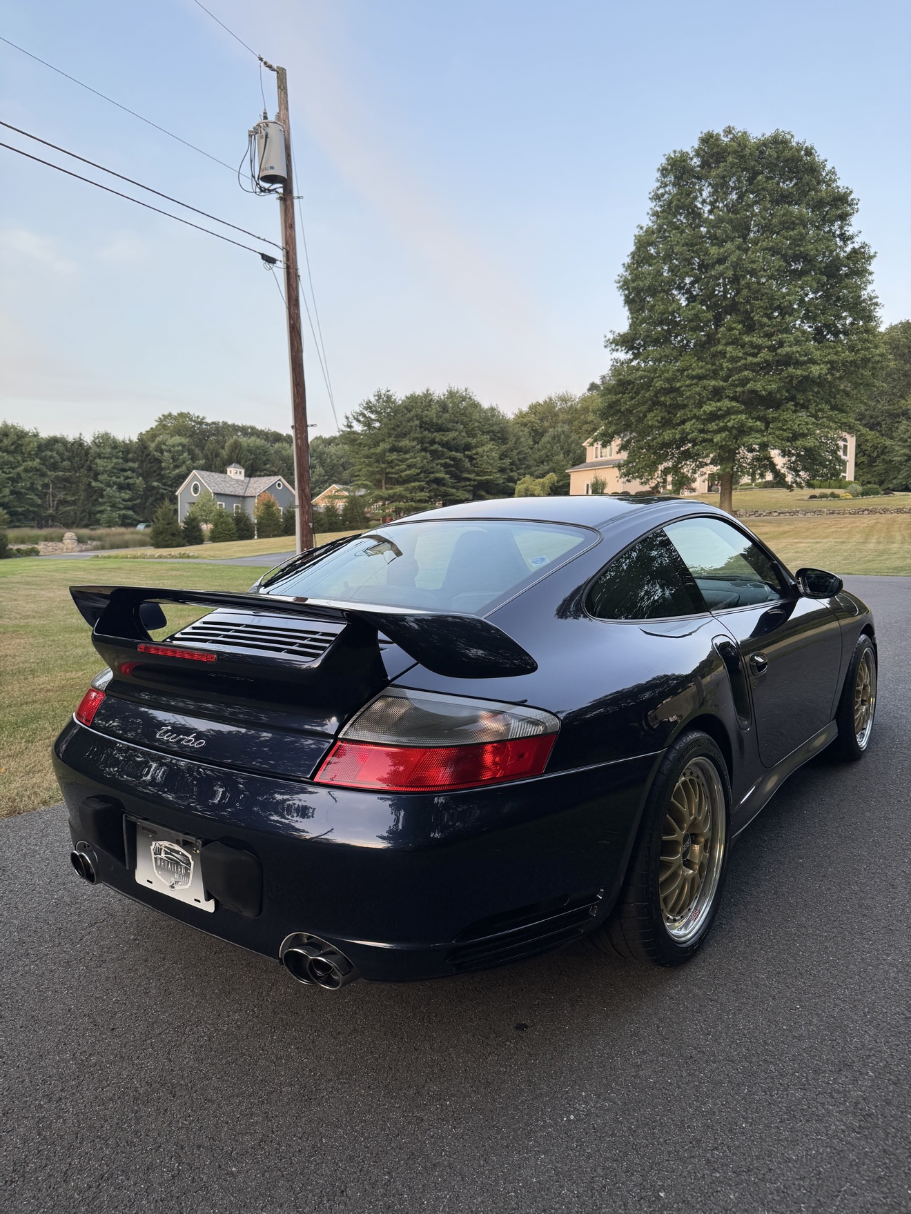 Black Porsche 911 Turbo rear three-quarter view with turbo script and rear wing