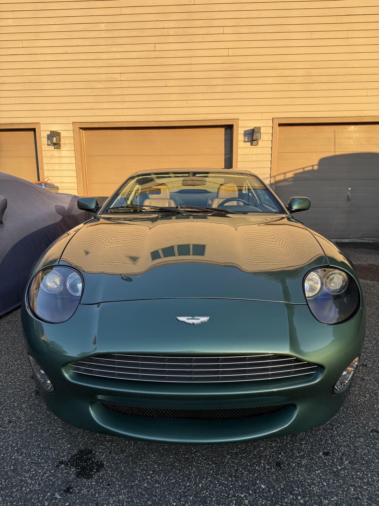 Front view of a green Aston Martin DB7 Vantage with tan leather interior