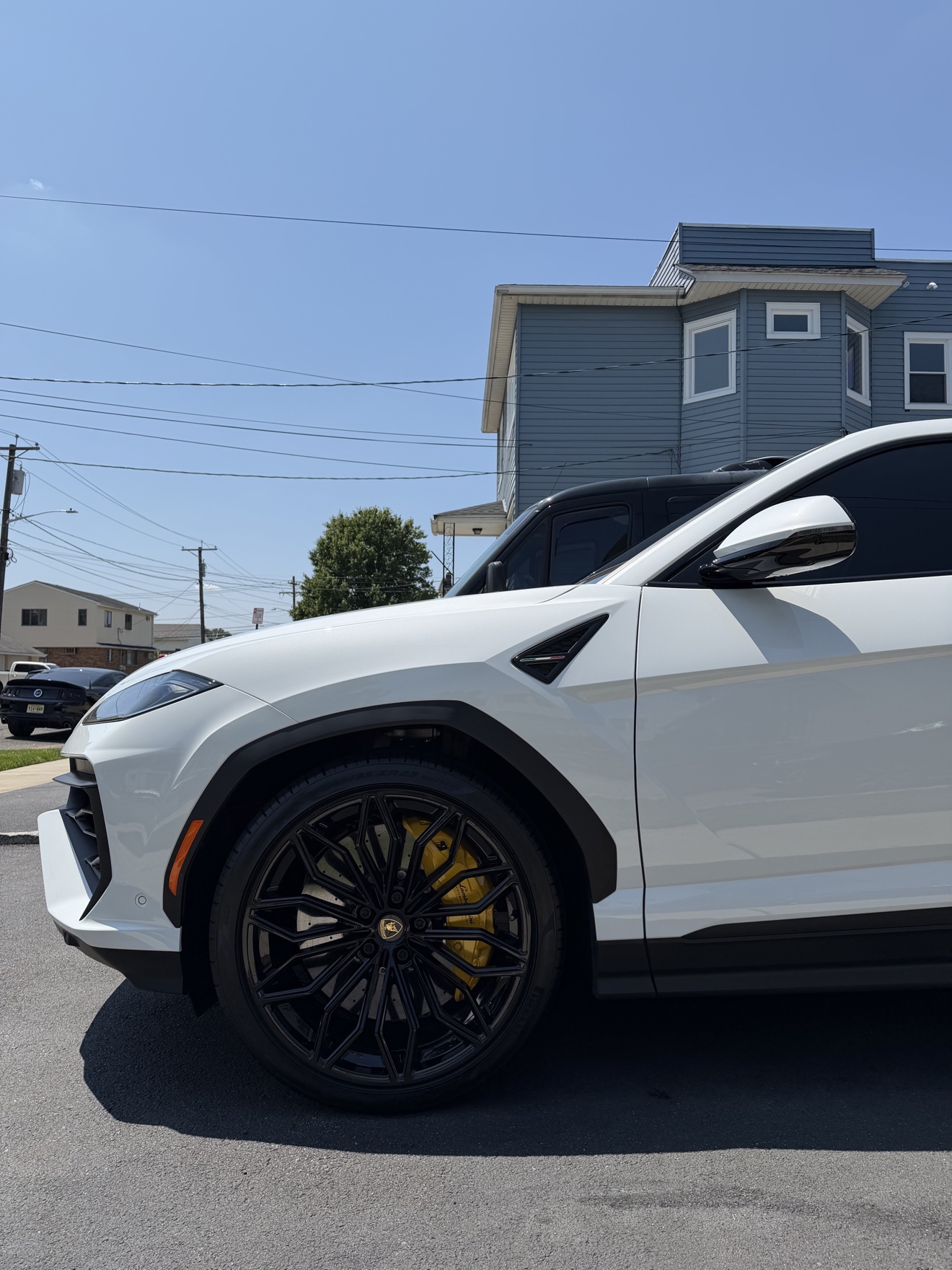 Close-up of Lamborghini Urus black wheel with yellow brake caliper