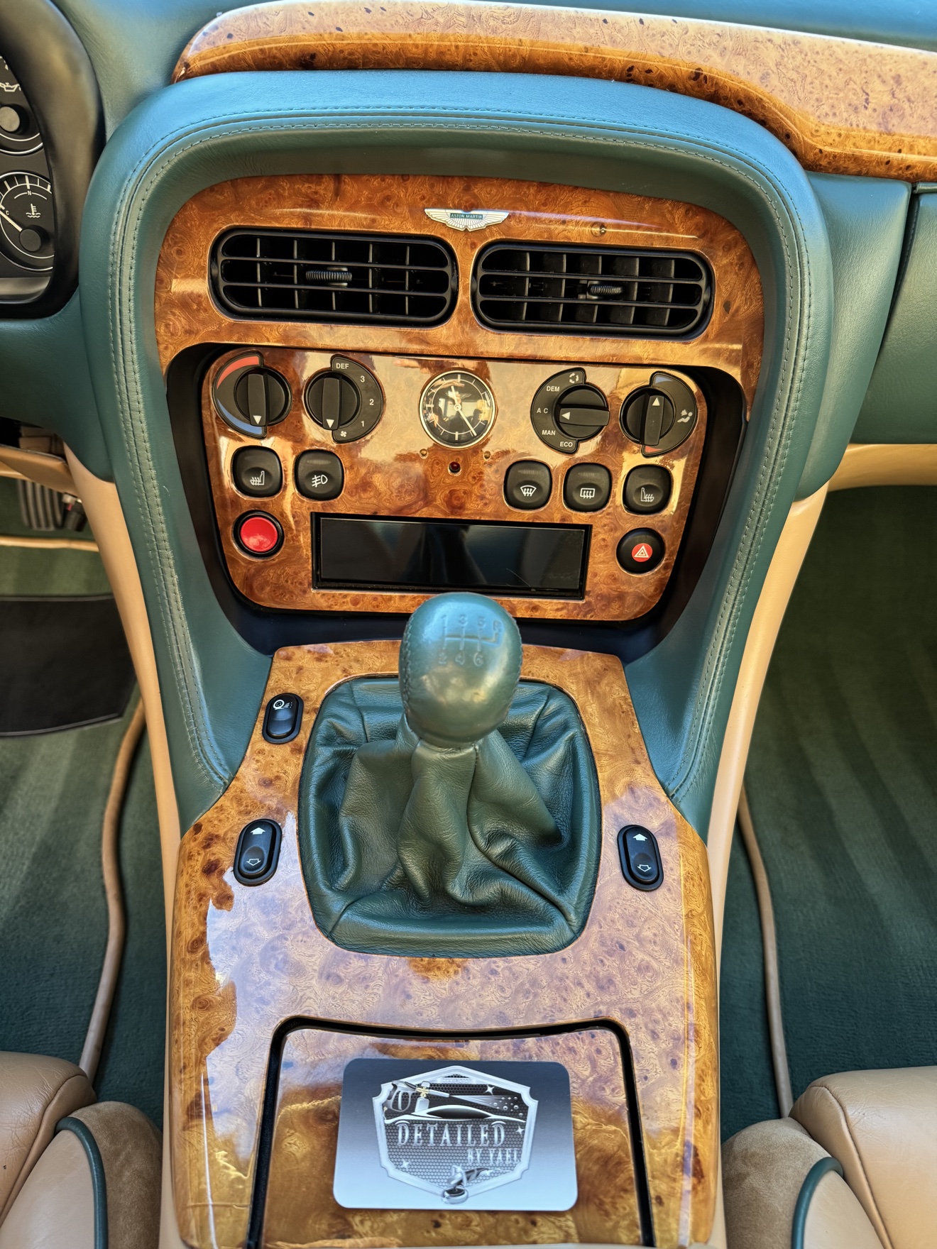 Aston Martin DB7 Vantage center console with manual shifter, walnut trim and Detailed by Yael business card