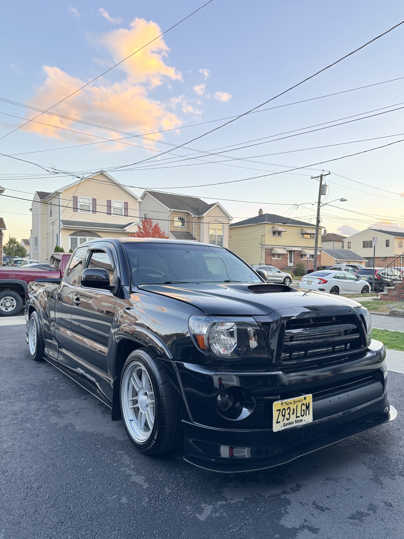 Black Toyota Tacoma X-Runner front three-quarter view with hood scoop after detailing