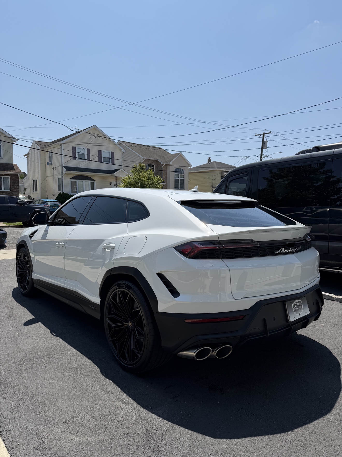 White Lamborghini Urus rear three-quarter view after detailing