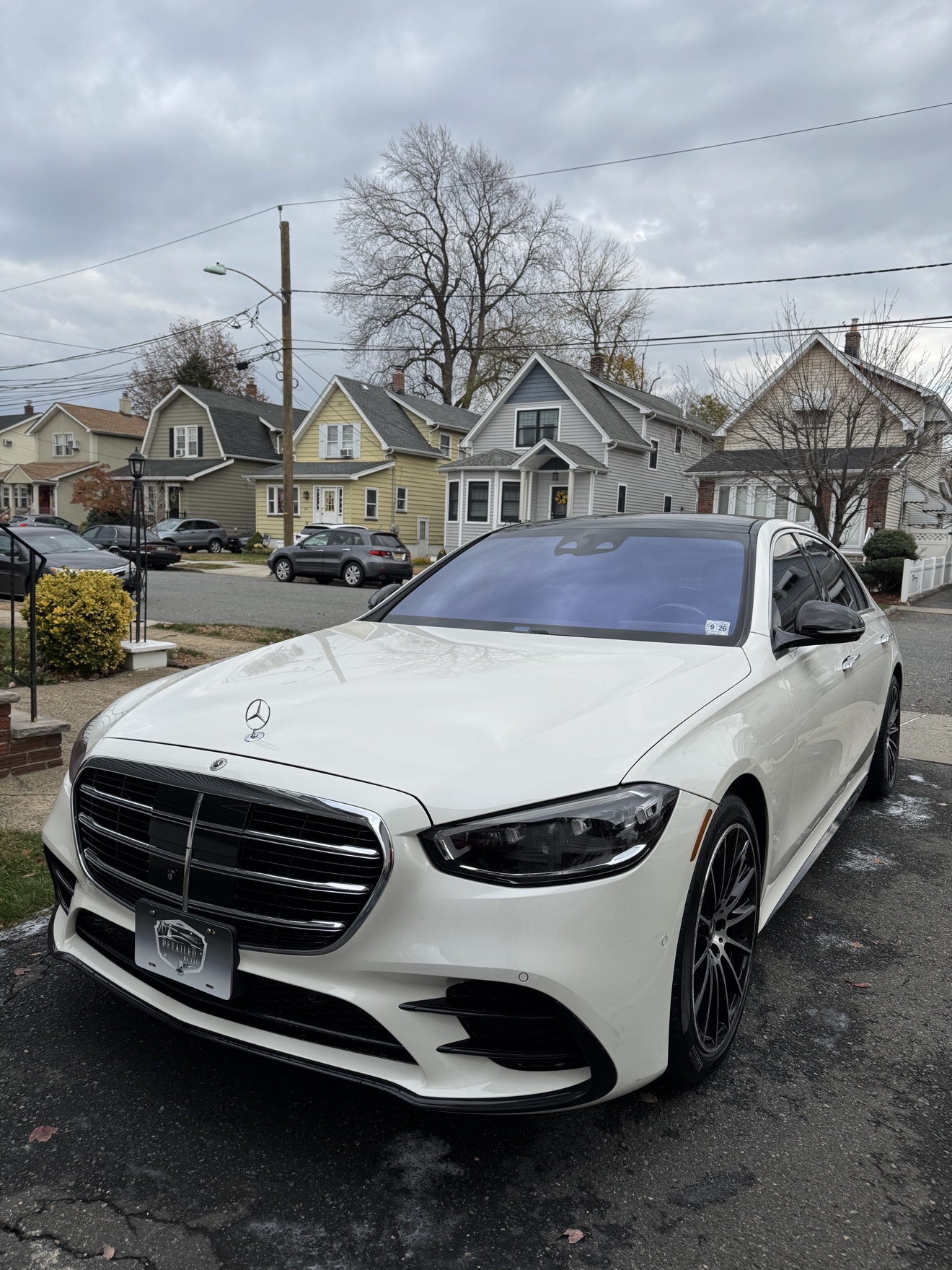White Mercedes-Benz S580 front angle view with black wheels after detailing