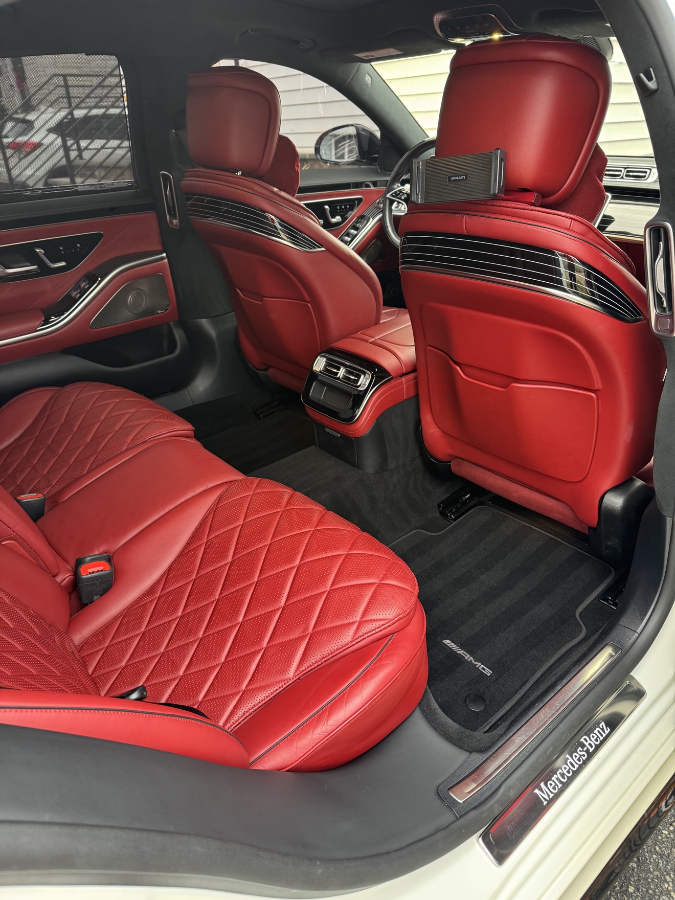 Mercedes-Benz S580 rear cabin with red quilted leather seats and Mercedes-Benz sill plate