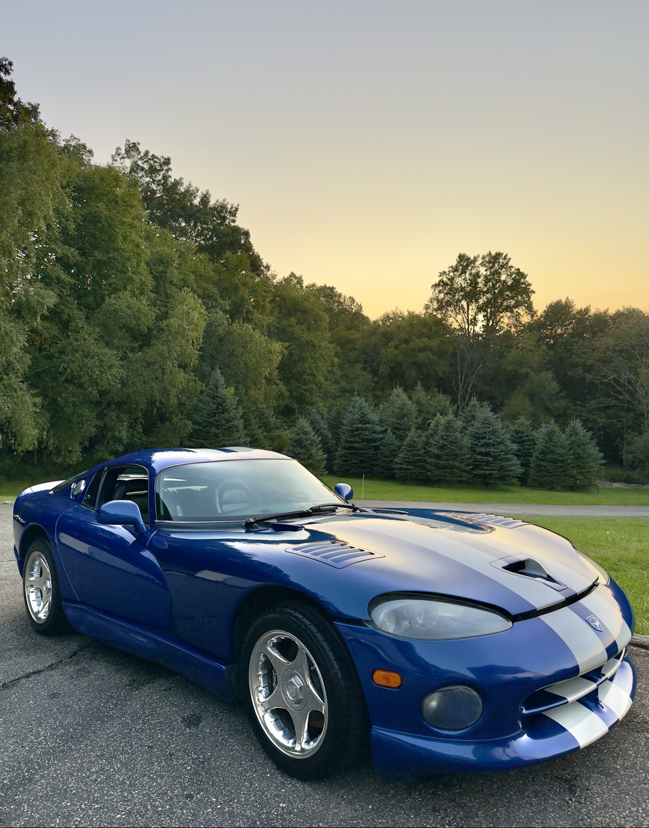 Blue Dodge Viper GTS with white racing stripes after detailing