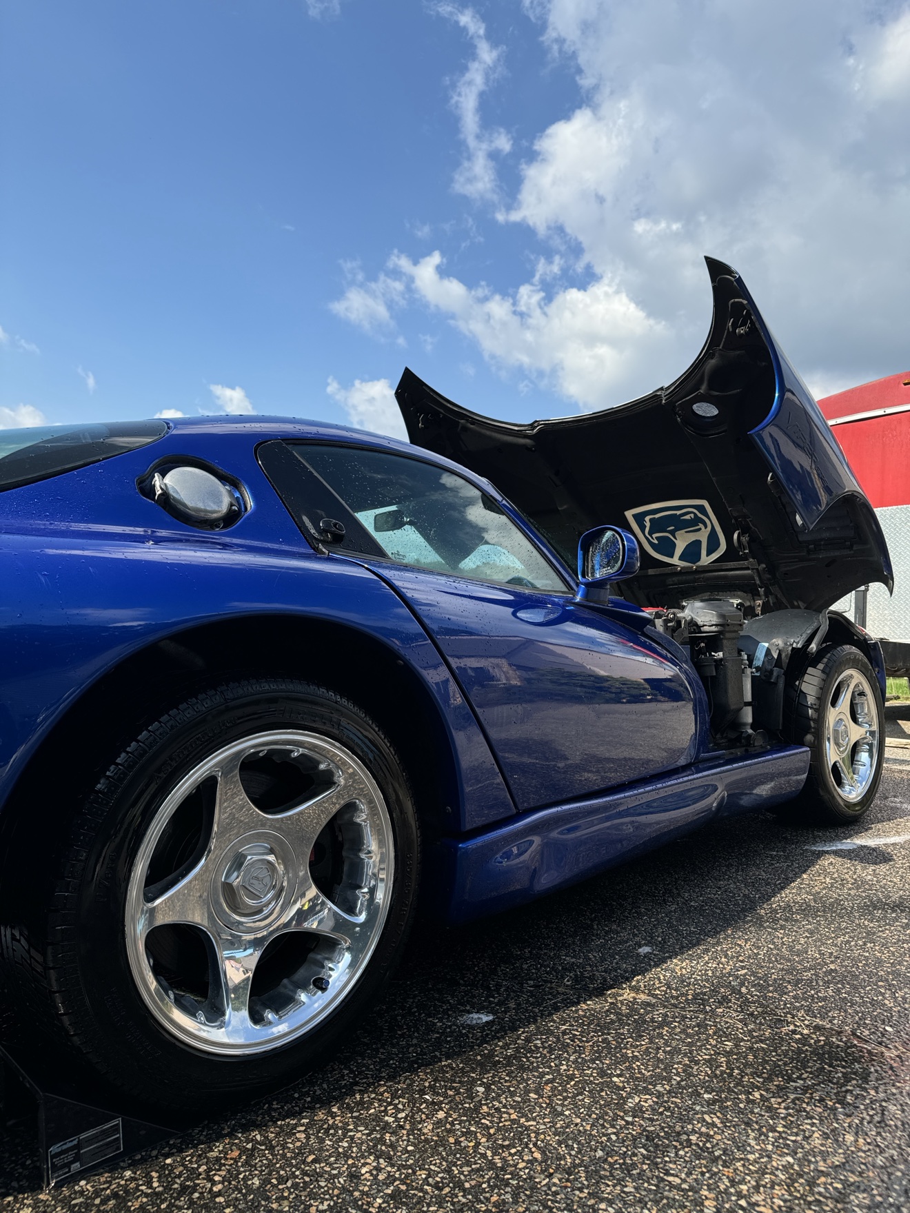 Blue Dodge Viper GTS side profile with hood open and polished wheels