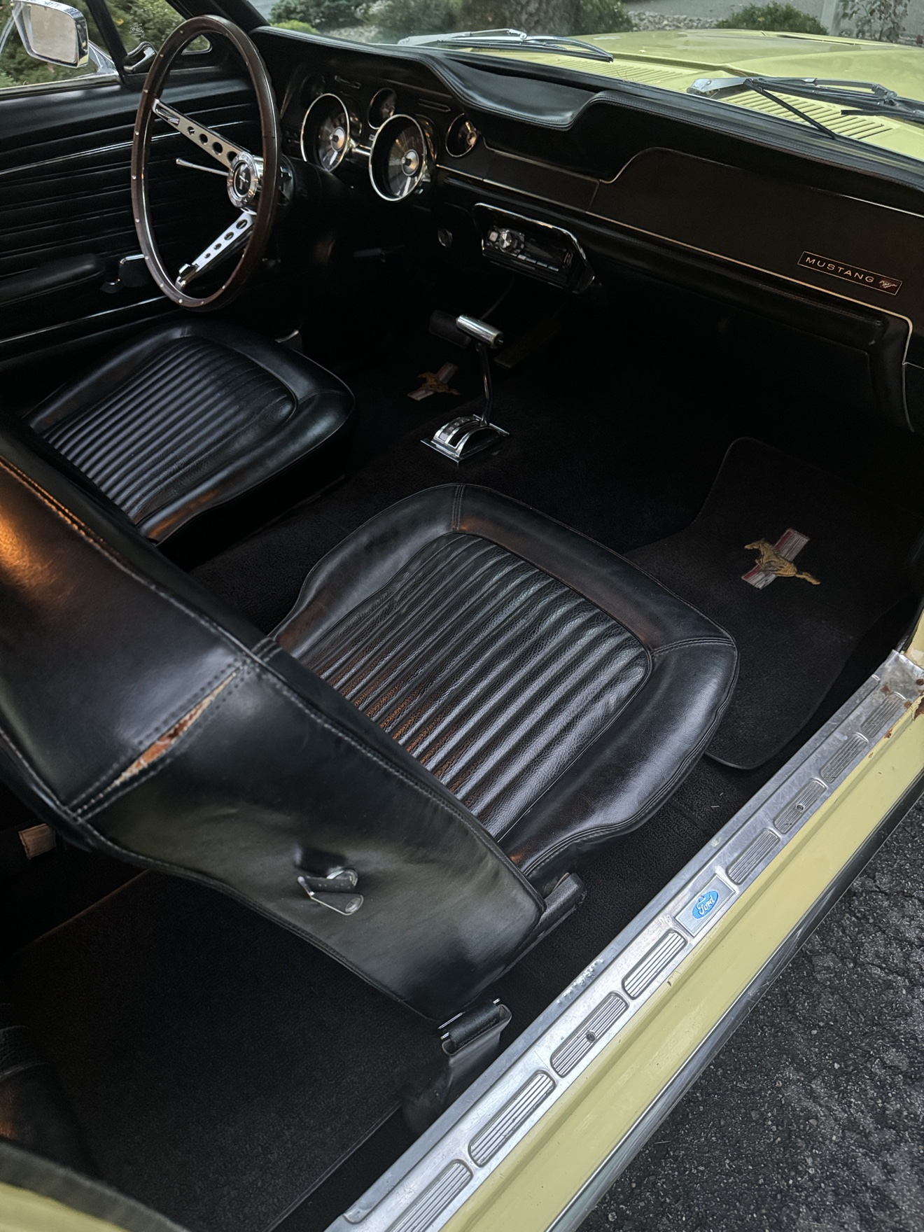 1968 Ford Mustang cockpit with round gauges and floor shifter
